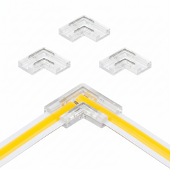 Four clear acrylic corner brackets shown on a white background, with one larger bracket demonstrating use on a yellow and white strip light.