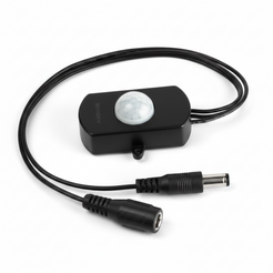 A black electronic signal or power adapter with a white circular sensor on top, connected by a thick black cable to two barrel-style connectors, shown on a plain white background.