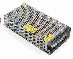 An industrial metal power supply unit with a perforated aluminum casing, yellow warning labels, and terminal blocks on the side, shown on a white background.